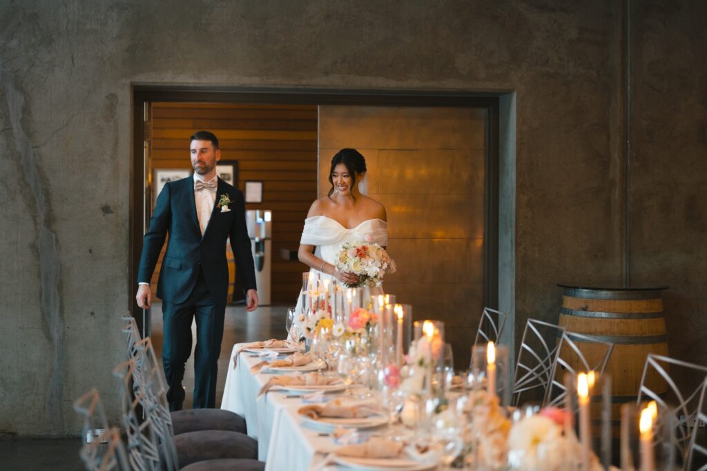 Newlyweds enter the candle-lit Terrace Room reception through concrete and copper doors at Novelty Hill-Januik Winery.