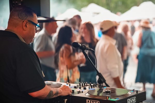 DJ spinning music at a Novelty Hill-Januik Cellar Circle summer wine club party in Woodinville.